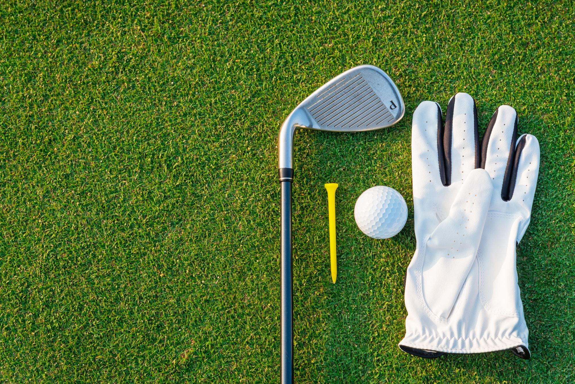 A golf club, golf pin, golf ball, and gloves