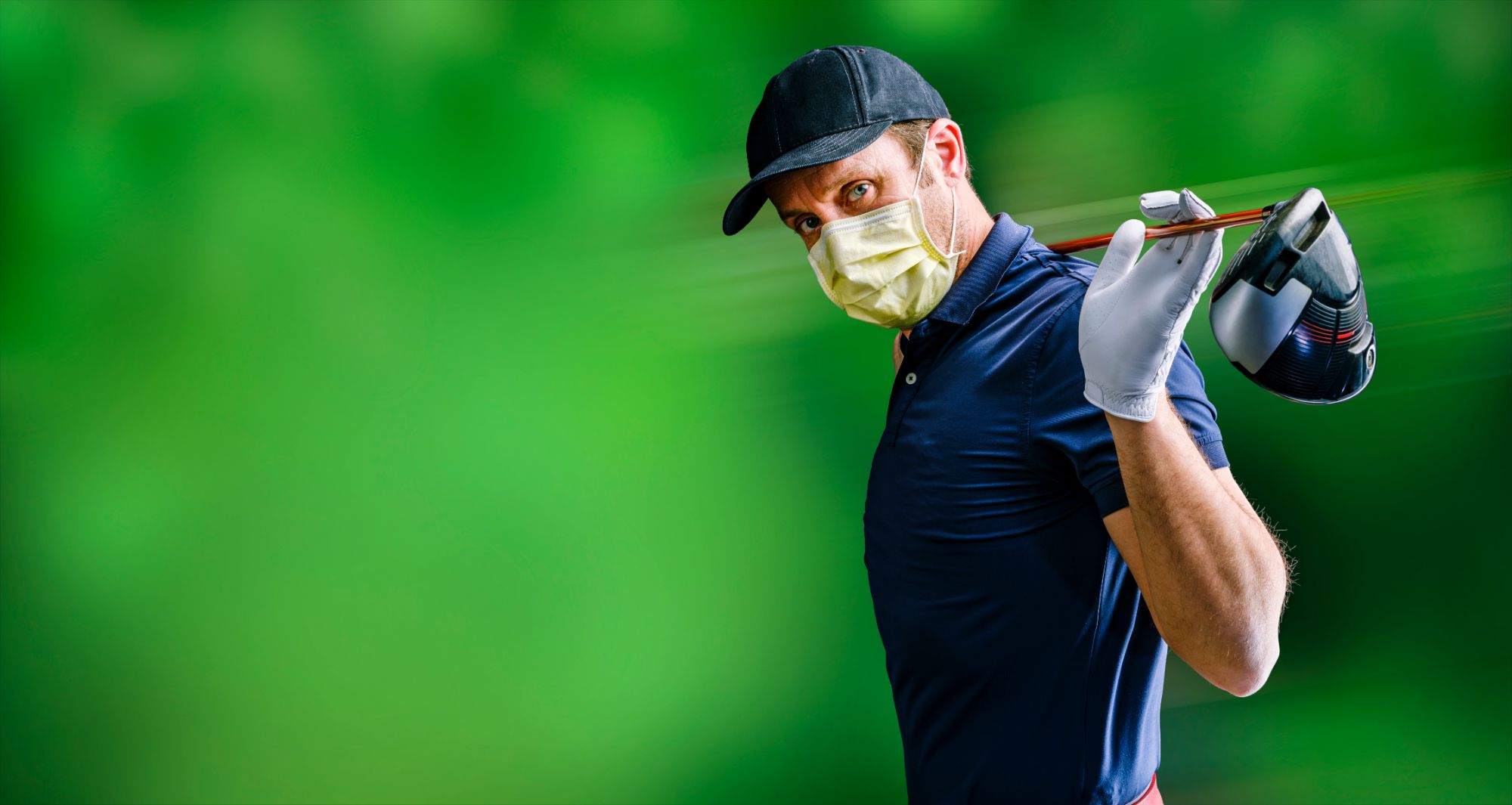 The golfer with the protective mask waits for his turn to make his best shot - COVID-19