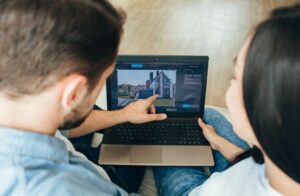 couple choosing new house using laptop scrolling the internet