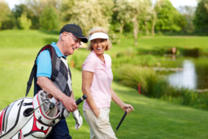 happy senior couple playing golf