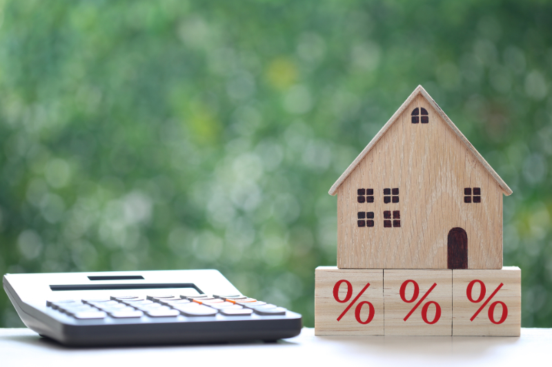 wood miniature house and calculator