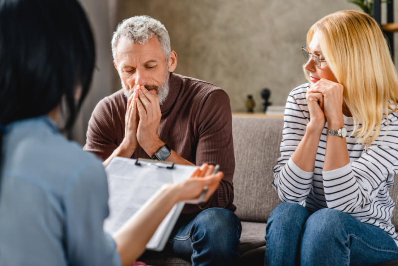 couple talking to real estate agent